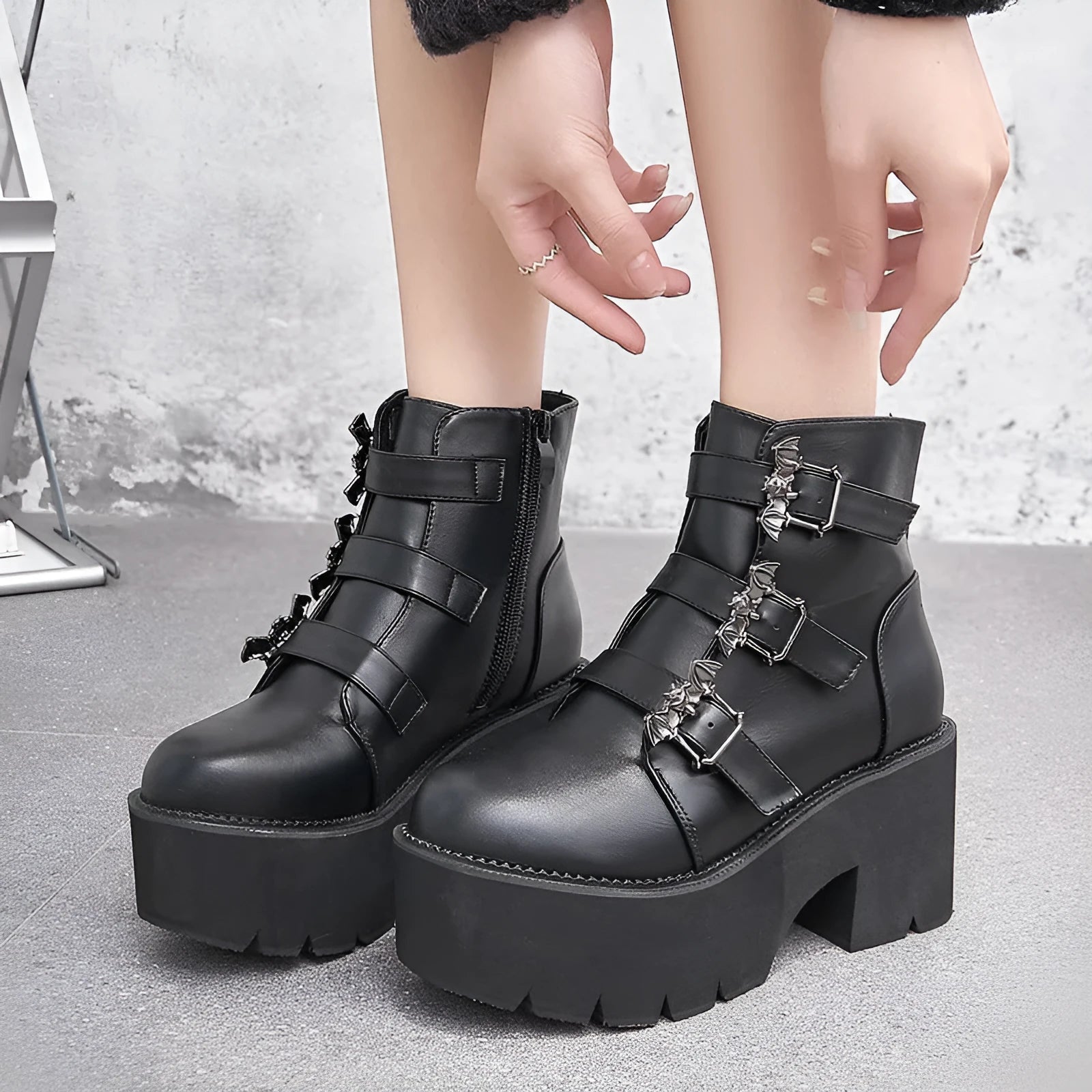 Black women's punk-style short Martin boots featuring a bat buckle, side zipper, and thick heel