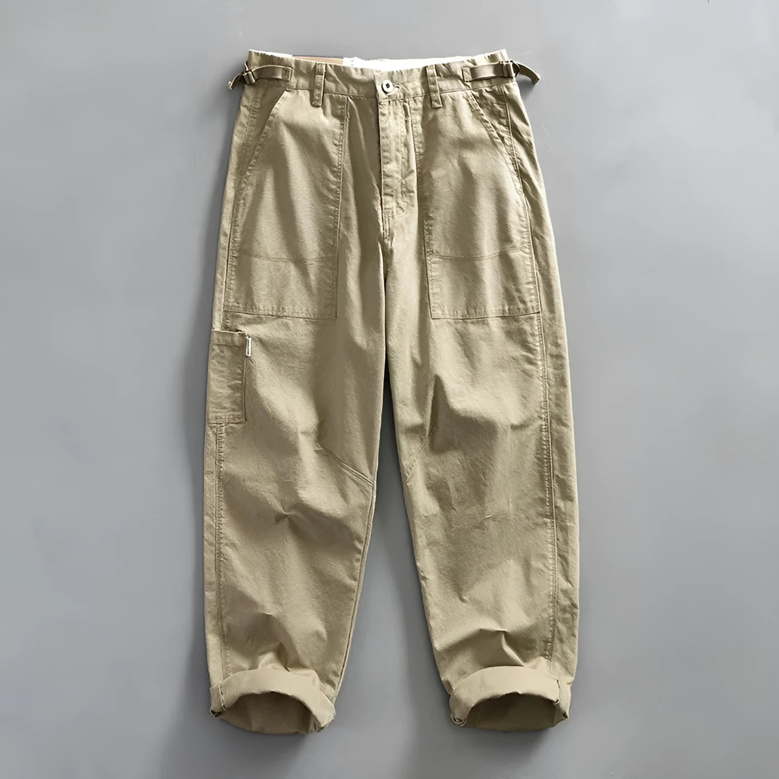 Men's straight-leg cotton casual trousers in apricot colour on a hanger