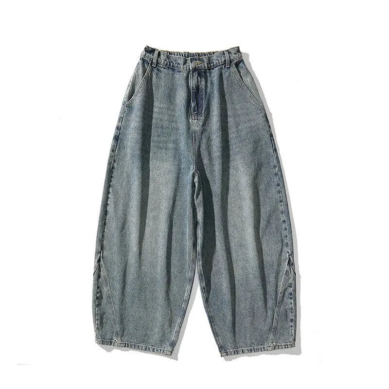 Men's plus-size baggy blue denim jeans with straight leg and low waist on a neutral background.