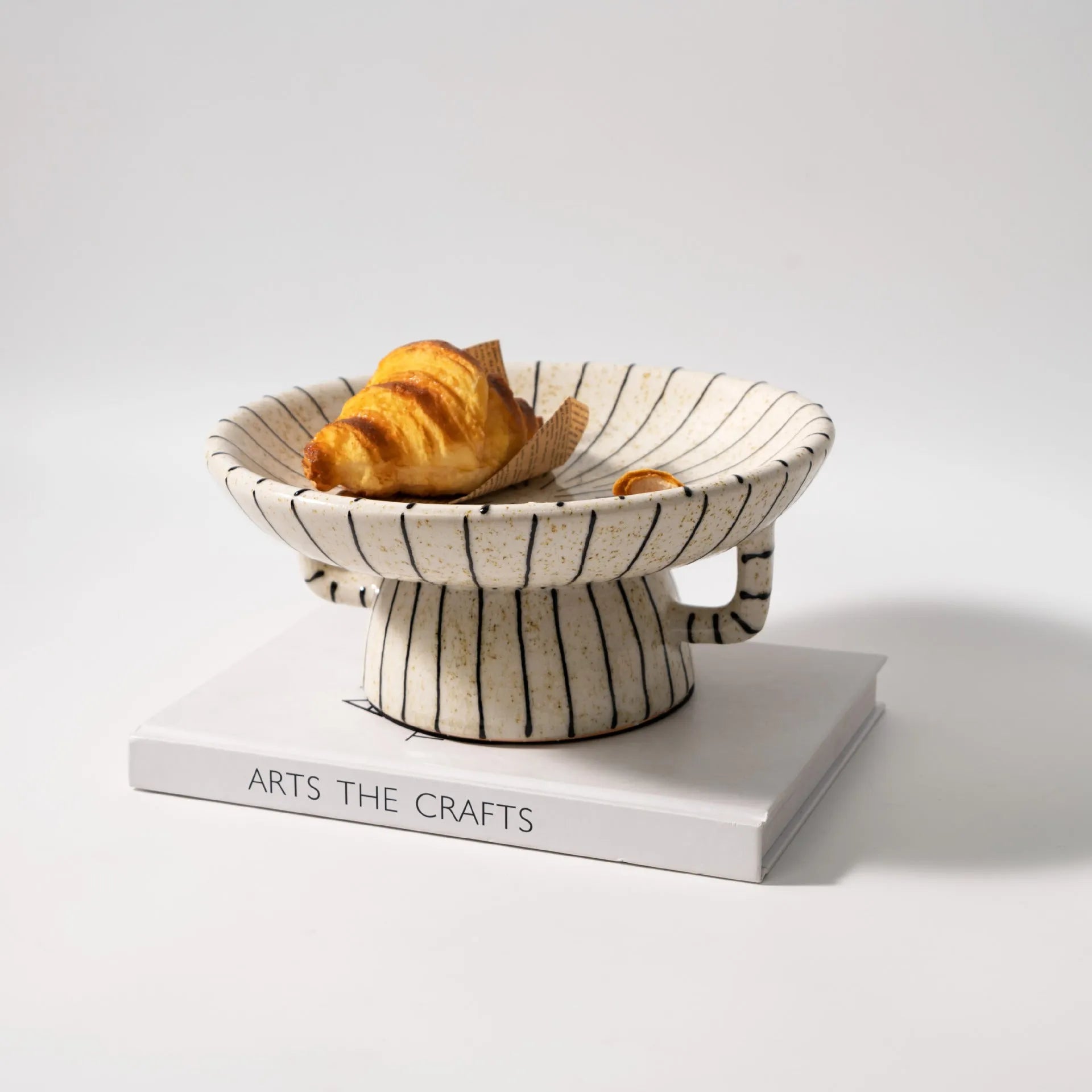 Black and white striped synthetic resin fruit plate on table