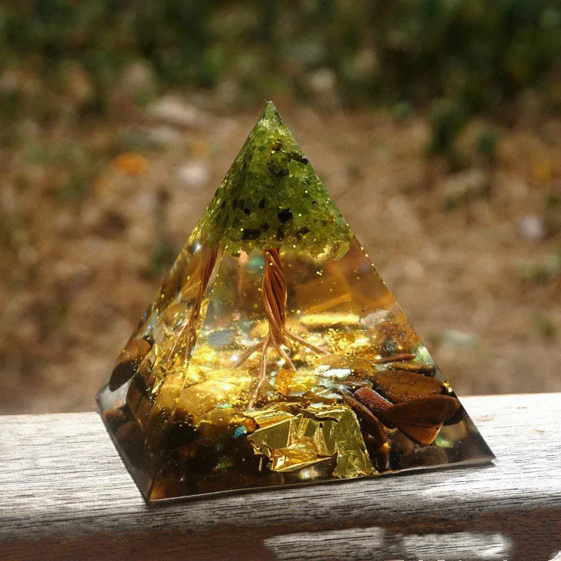 Small 6cm clear epoxy resin pyramid ornament with embedded pieces of natural coloured crystal gravel.