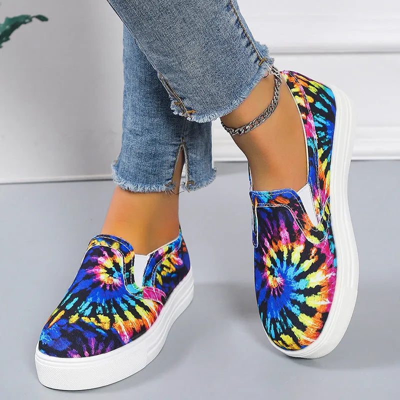Women's blue low-top canvas sneaker with flat rubber sole on a plain background.