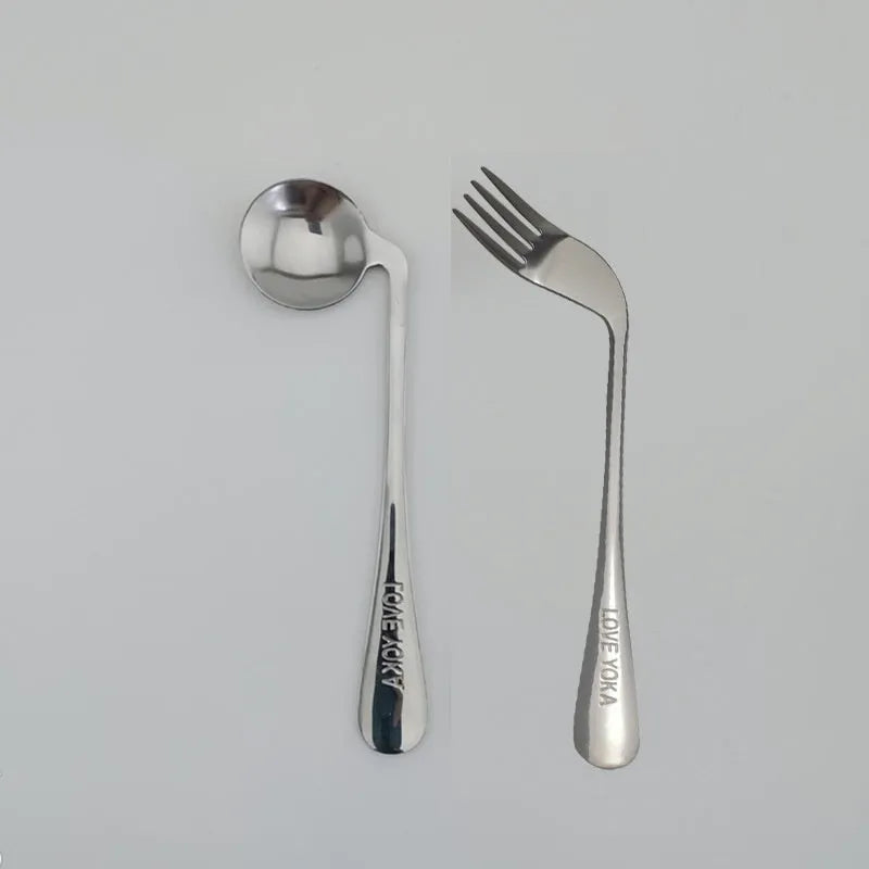 Stainless steel adaptive spoon for elderly feeding care, left hand version on white background