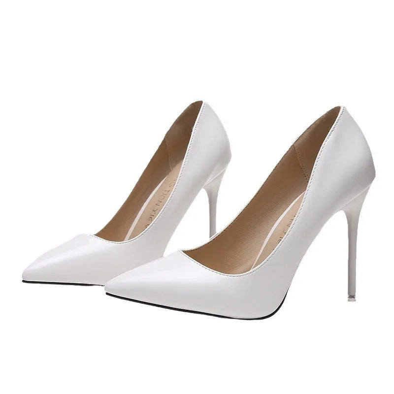 Women's nude stiletto heel pointed toe high heel pump in apricot colour with a buckle.