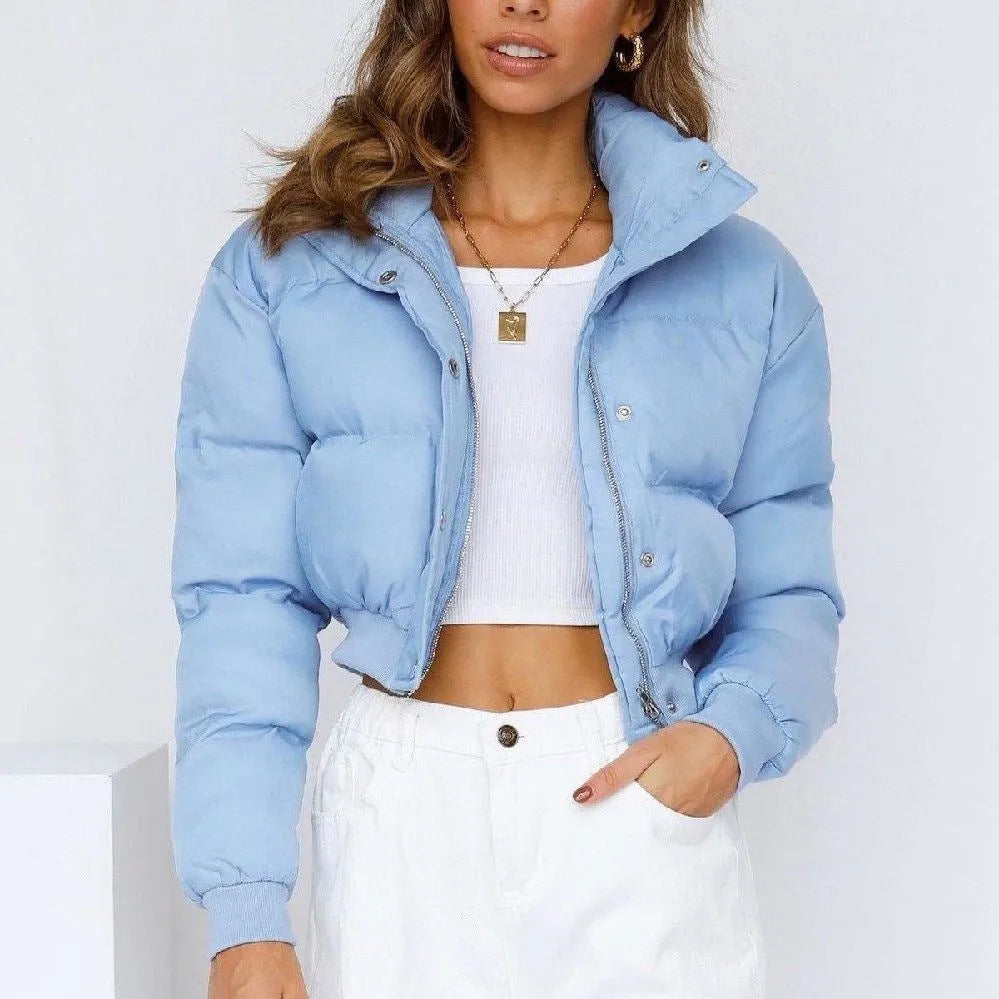 A woman's loose-fitting long-sleeve polyester jacket in blue, shown on a hanger.