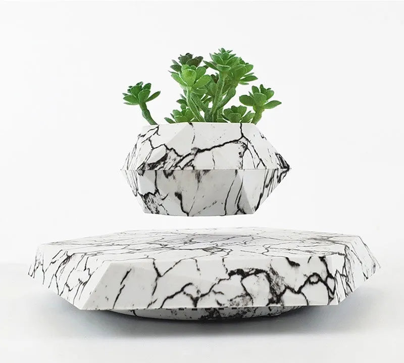 Marbled colour levitating plant pot floating above base with magnetic technology