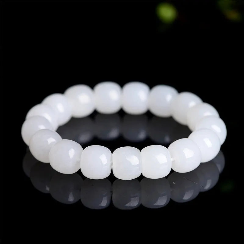 White Hetian jade barrel bead bracelet on wrist, showing unisex design and elasticated band.