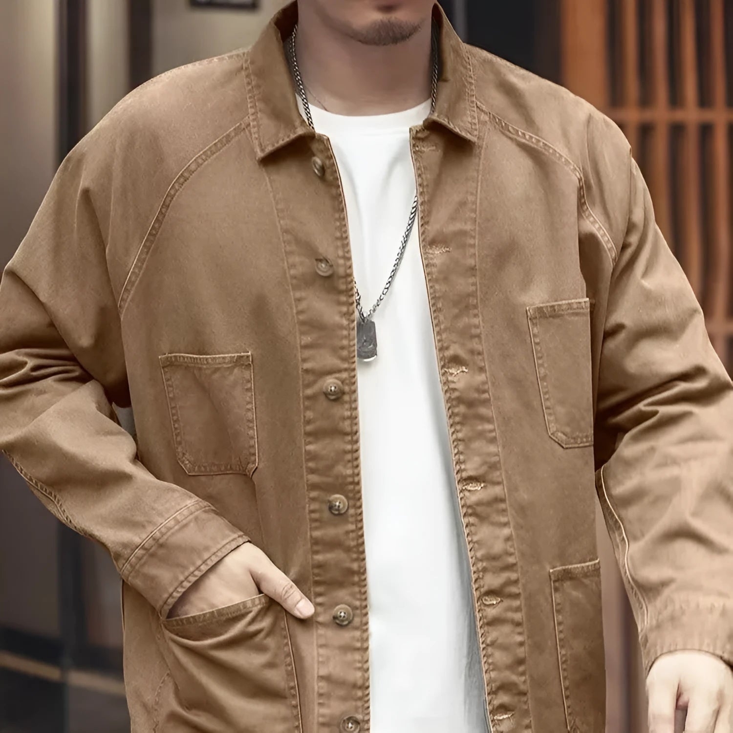 Men's khaki cotton blend denim jacket with loose fit and multiple pockets on a plain background