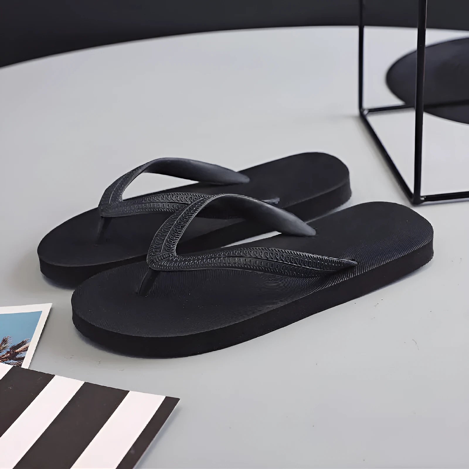 Rubber beach flip-flops with fish label in green, red, blue, or black, showing non-slip patterned sole.