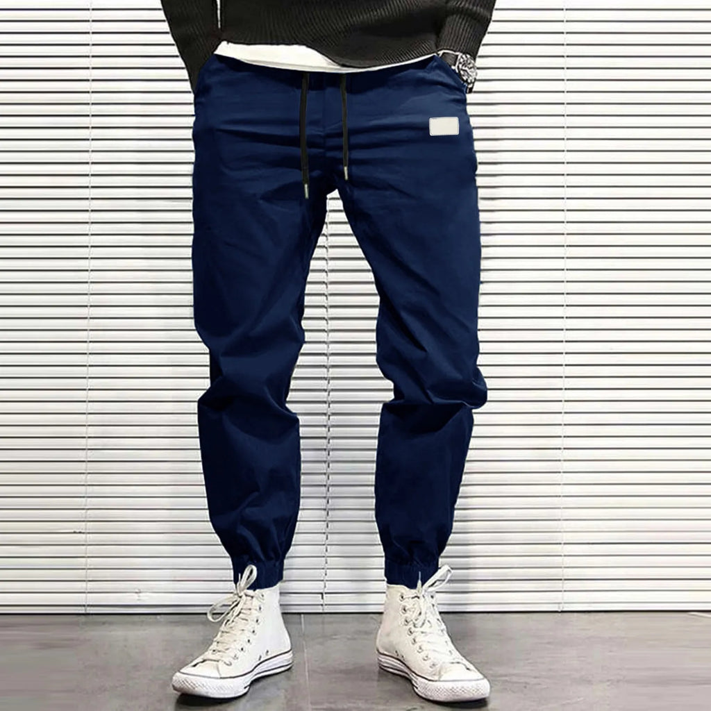 Men's quick-dry loose tapered running trousers in army green, side view on model