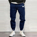 Men's quick-dry loose tapered running trousers in army green, side view on model