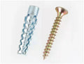 Metal expansion anchor with barbed serrated tube and screw for concrete and brick walls.