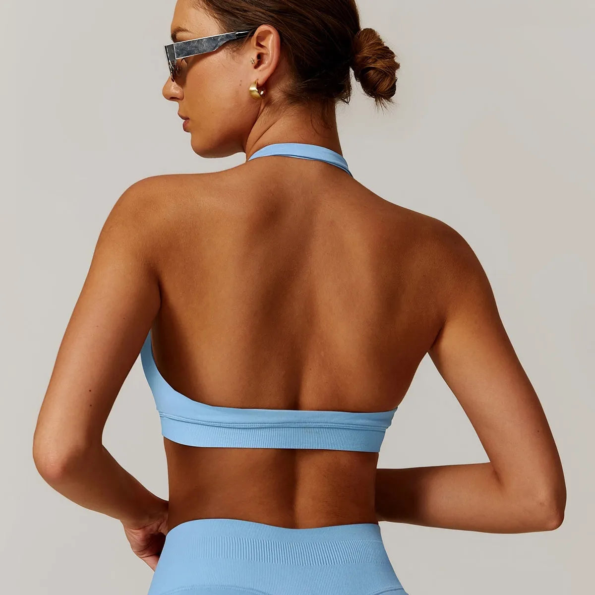 Women's black halter sports bra with hollow back and removable pads for yoga and workouts