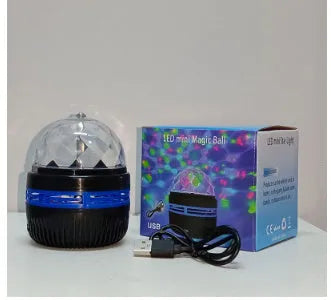 LED star galaxy projector lamp with removable acrylic shade on a table, showing USB cable.
