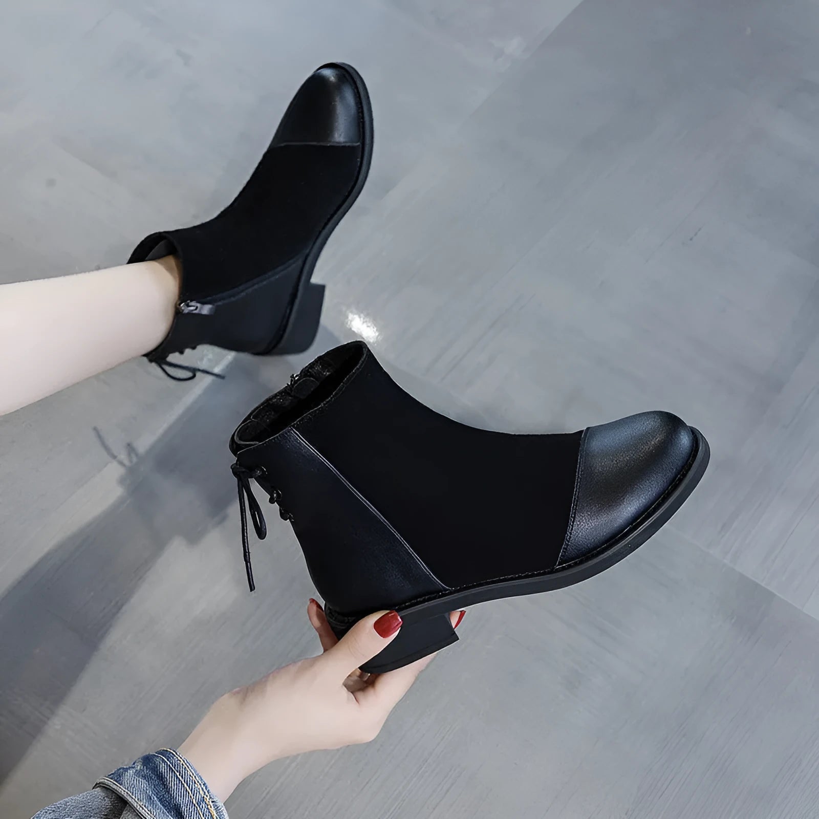 Black women's knee-high Martin boots with side zip, round toe, decorative bow, and rubber sole.