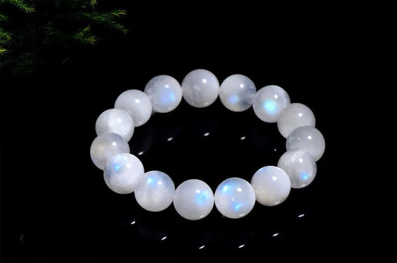 Natural blue moonlight round moonstone bead bracelet on a white background showing polished gemstone beads.