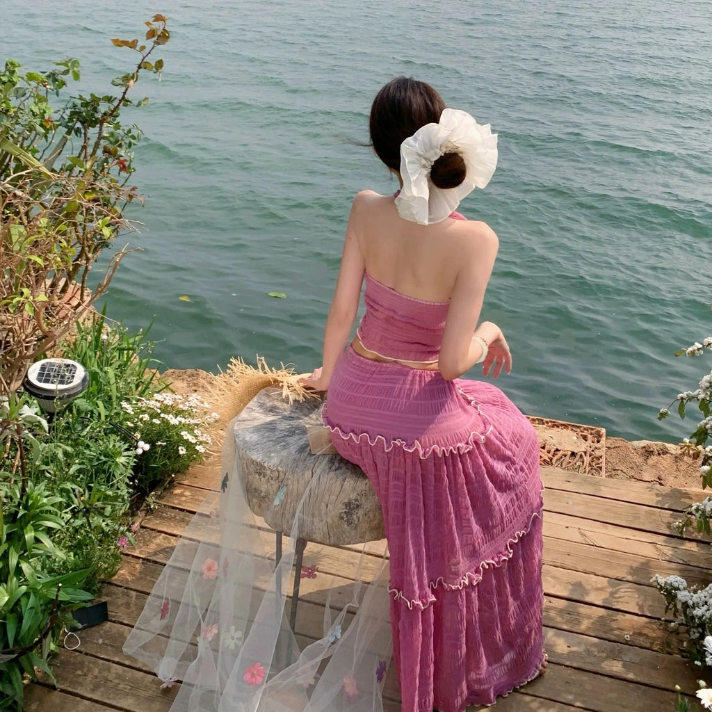 Three-piece bikini swimsuit set with halterneck top, long skirt, and shorts in pink or black, sizes S to XL