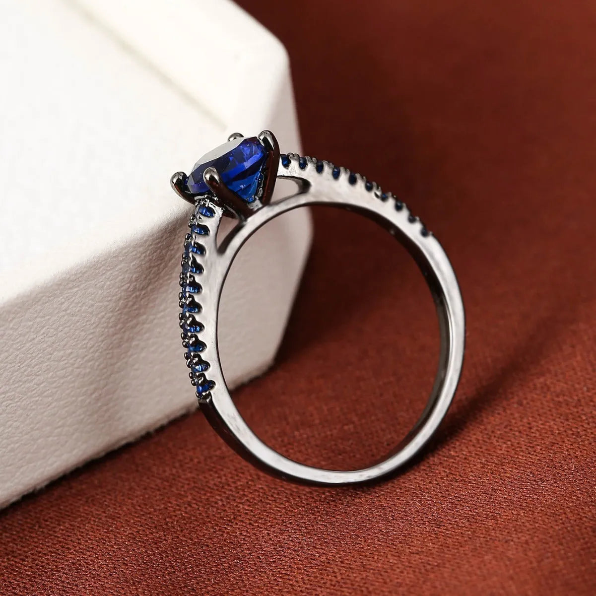 Geometric hexagonal copper ring in a silver white electroplated finish on a hand.