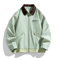 Man wearing a mint green loose fit polyester couple jacket with contrast lapels and side seam pockets.