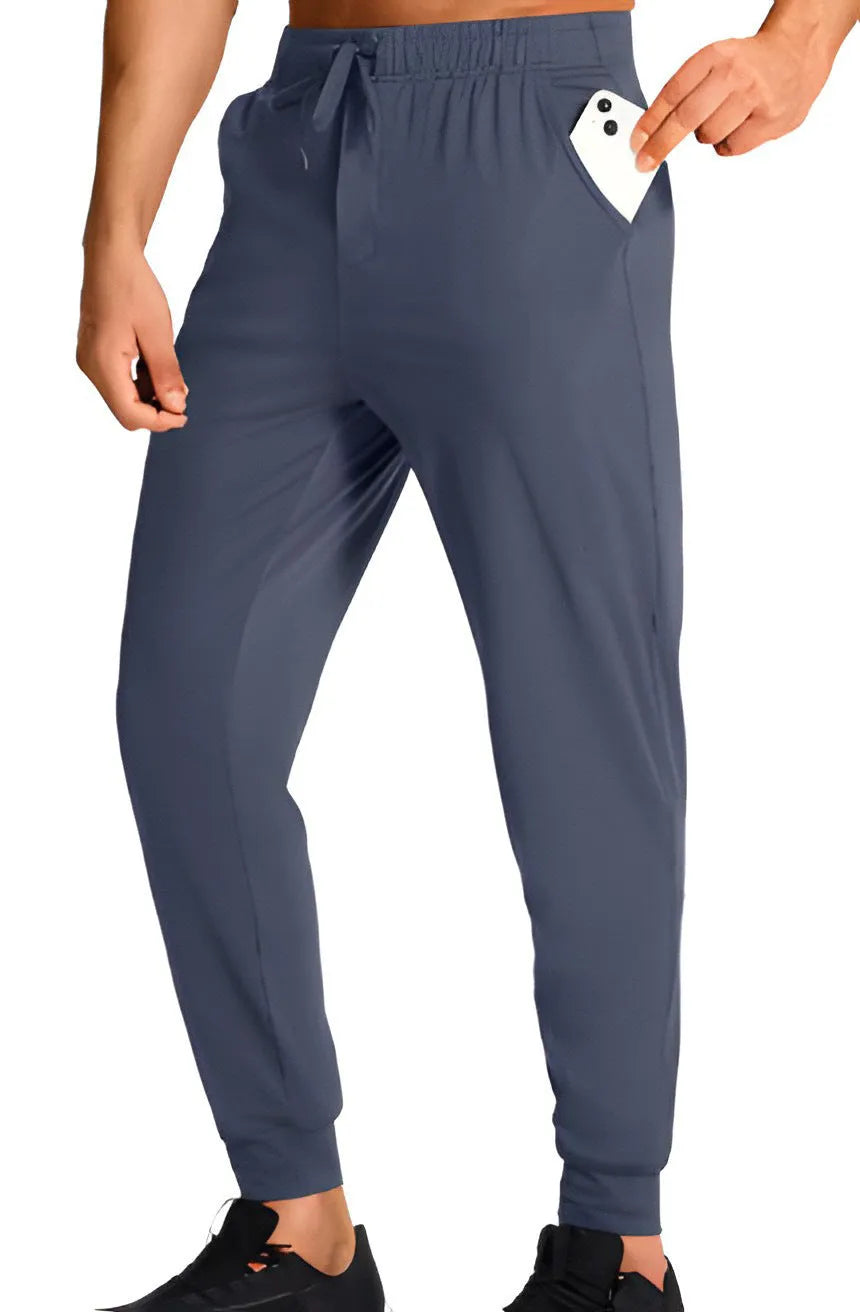 Men's loose fit solid colour casual trousers in polyester fabric on a hanger.