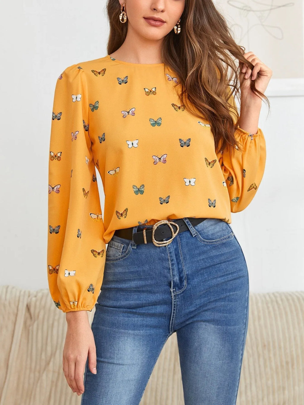 Green women's long sleeve shirt with butterfly print, showing loose fit and button front.