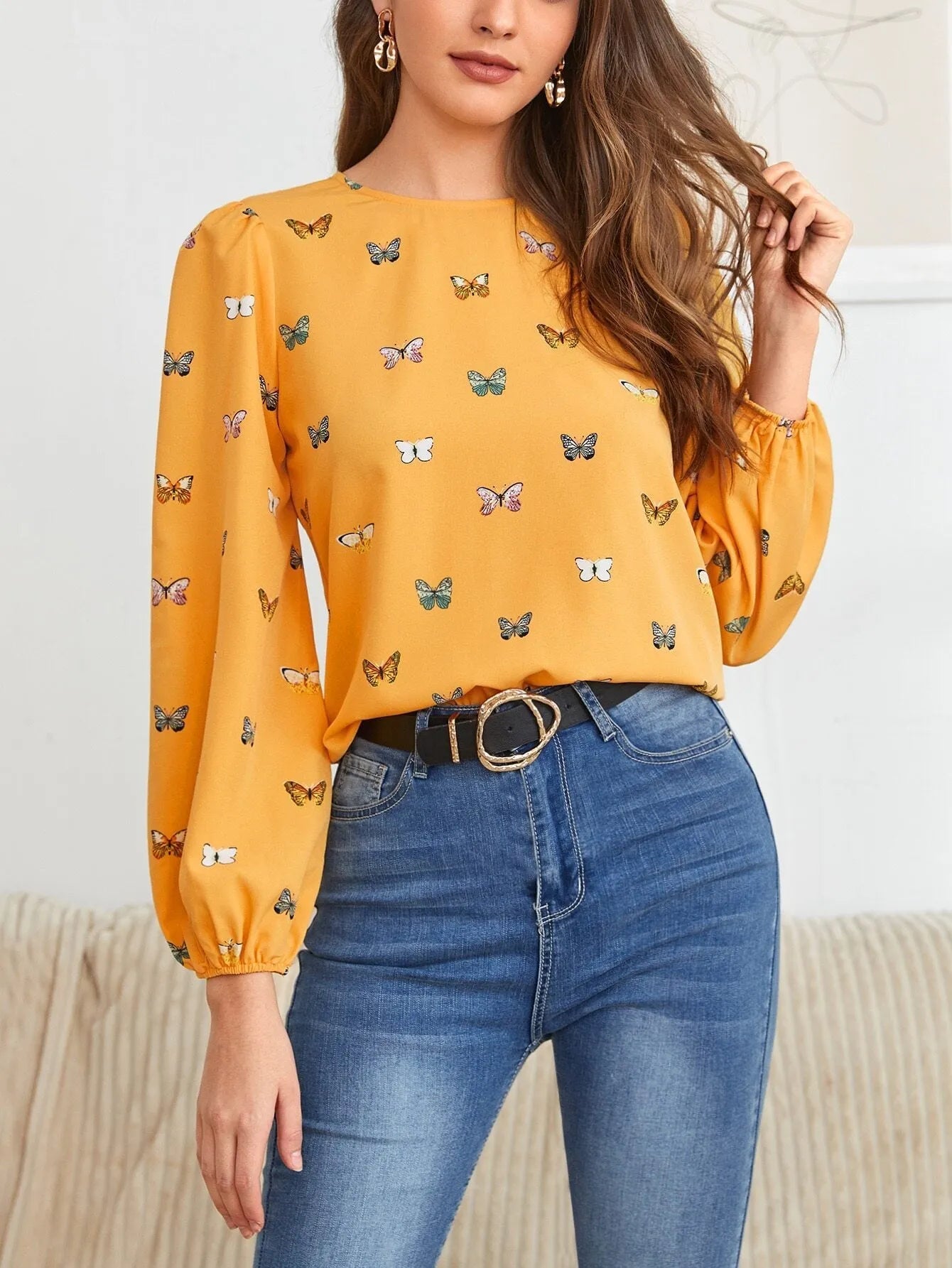 Green women's long sleeve shirt with butterfly print, showing loose fit and button front.