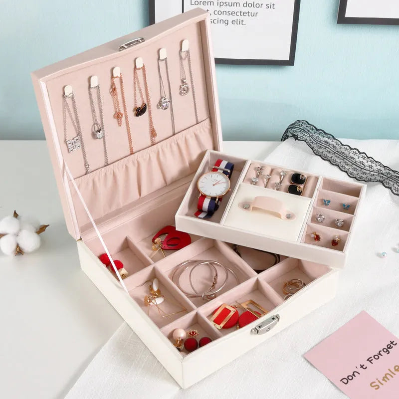Red or white PU leather jewelry storage box with multiple compartments for necklaces and rings.