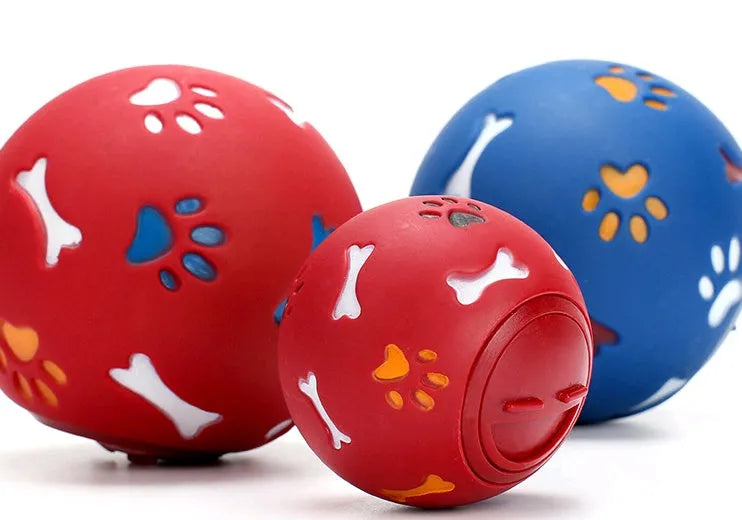 Rubber puzzle ball for dogs with uneven surface, footprints pattern, blue and red colours, sizes 7.5cm and 11cm