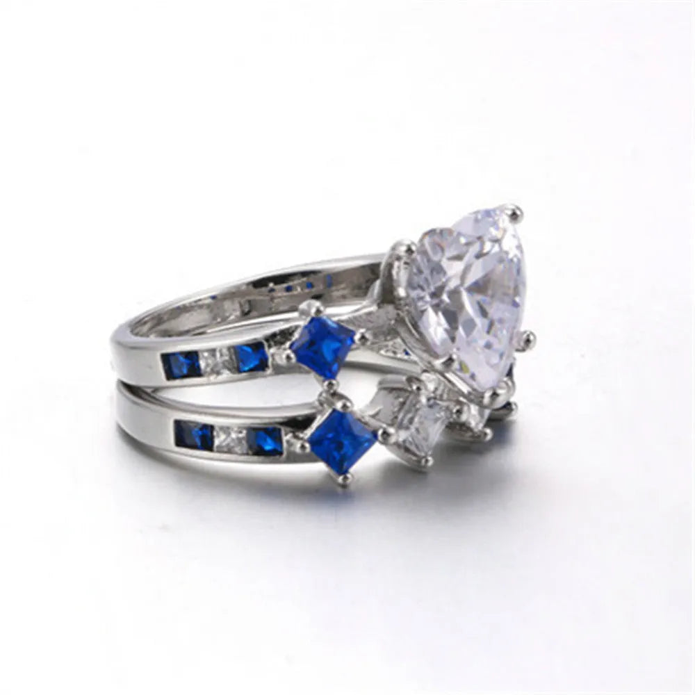 Silver-tone alloy heart-shaped geometric ring set on hand showing silver finish and multiple rings