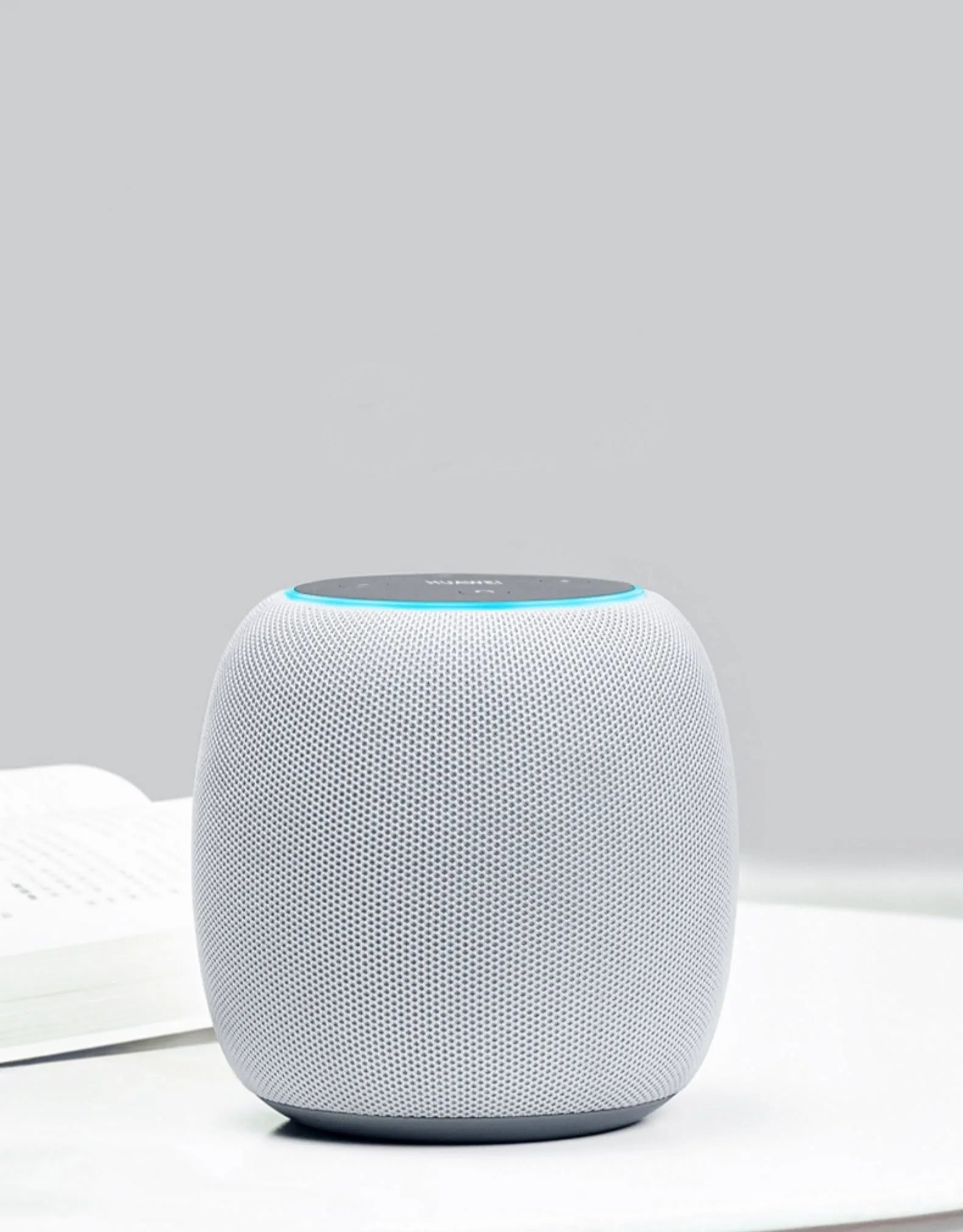 Compact mini AI voice assistant Bluetooth smart speaker with six microphones and control buttons.
