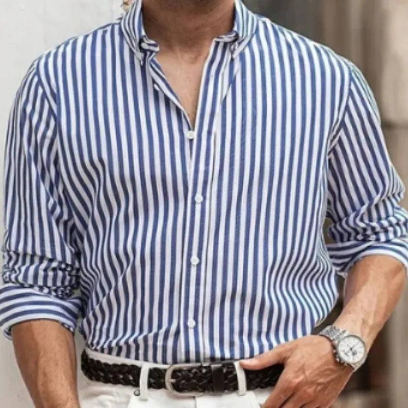Man wearing a loose-fit khaki striped button-down cardigan-style shirt.