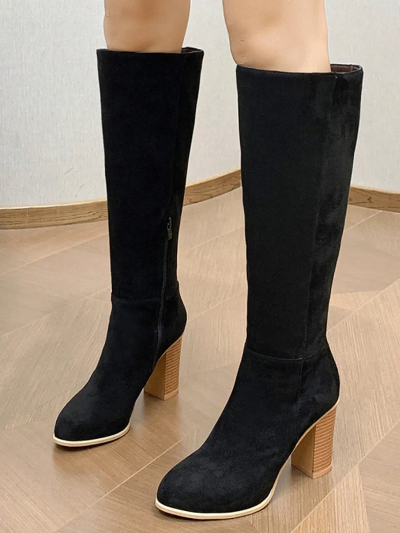 Black women's square toe high heel fashion boots made from artificial PU material.