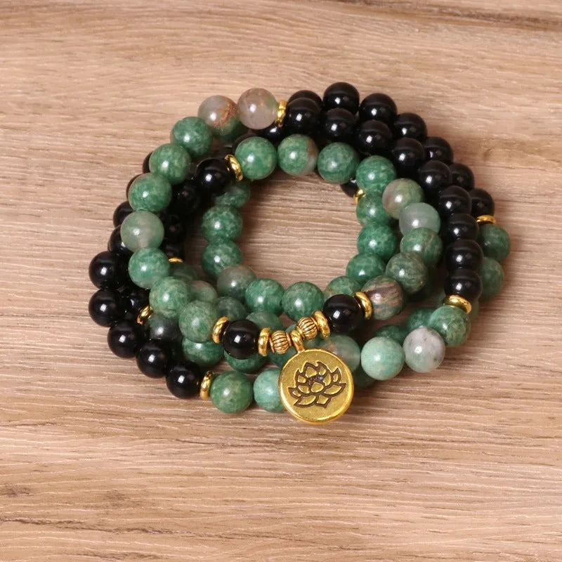 Green and black elastic beaded alloy bracelet showing stretch design and natural style