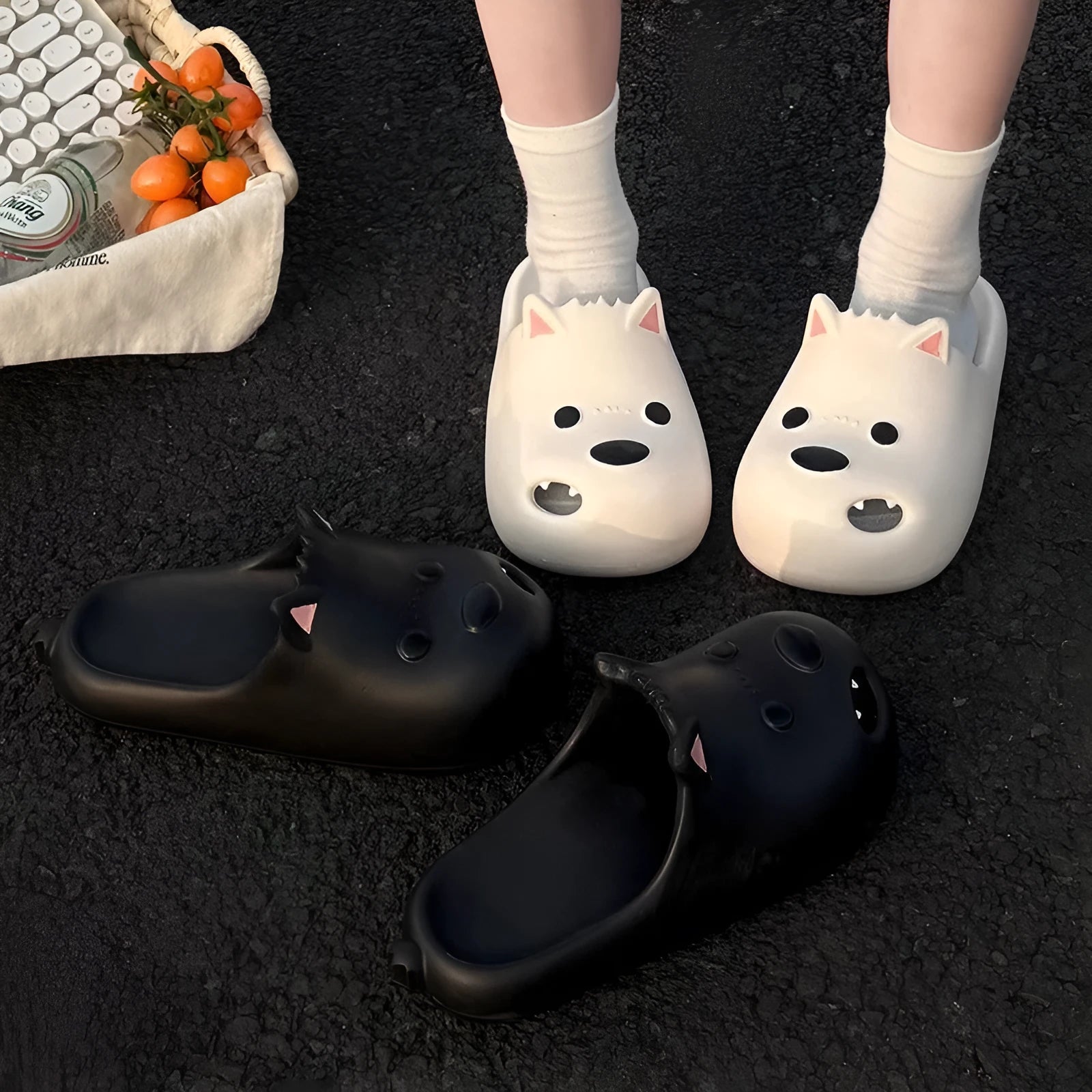 Women's black EVA foam puppy slippers with a toe cap sandal design on a white background.