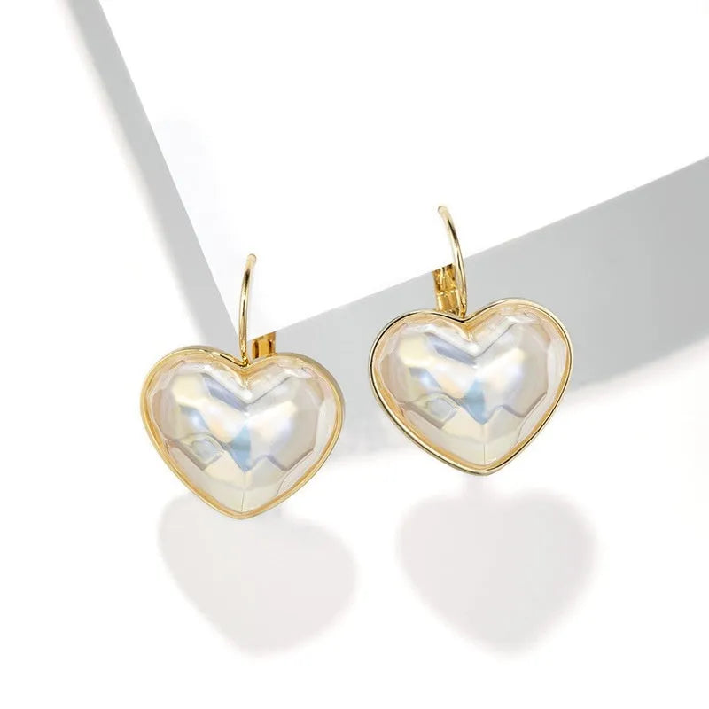 Pair of gold-coloured alloy clip-on earrings with a fashion niche design for women.