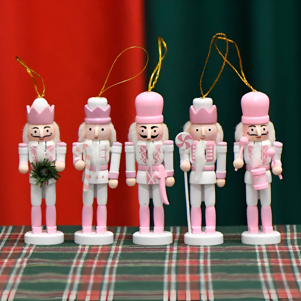 Five pink wooden nutcracker soldier puppets each 13cm tall arranged as Christmas garland ornaments