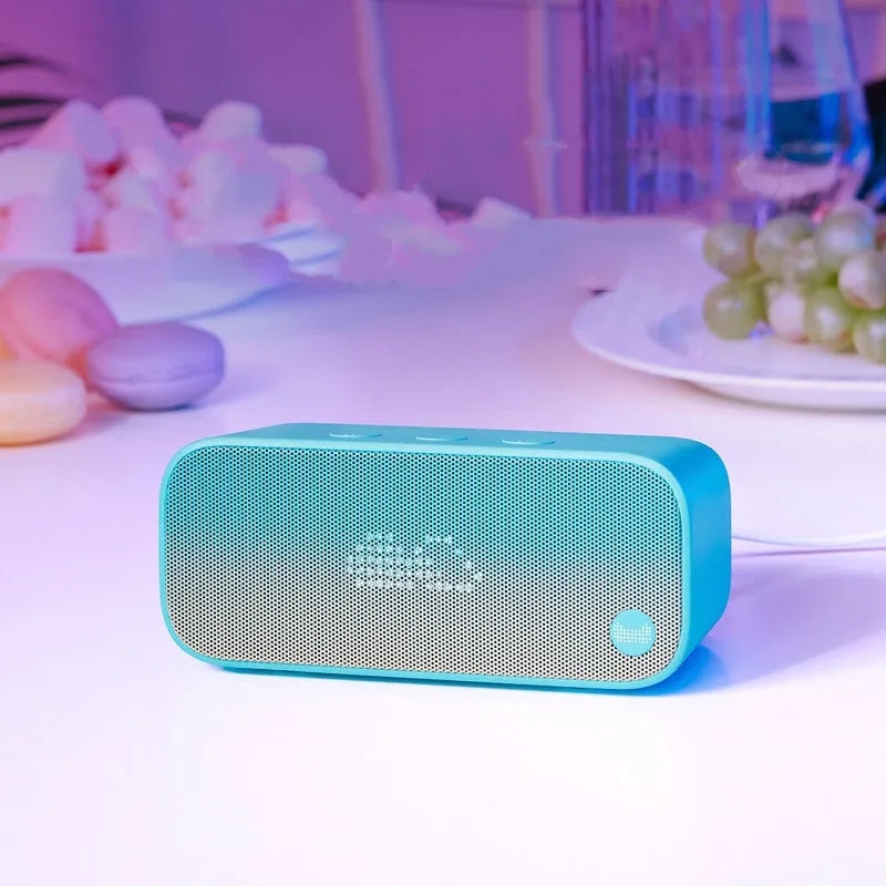 Elf Sugar Cube Artificial Intelligence Speaker in blue, green, red, or white plastic bookshelf design