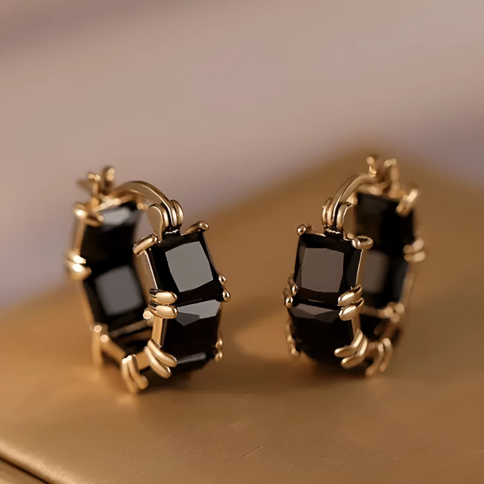 Geometric U-shaped gold ear ring with round black zircon stones
