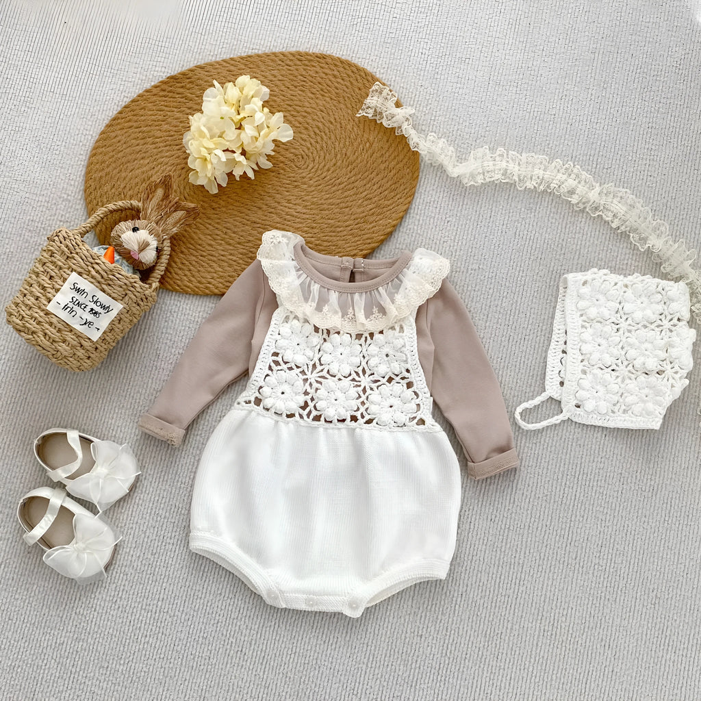 Beige baby romper with flower cutout strap and matching hat on a baby girl