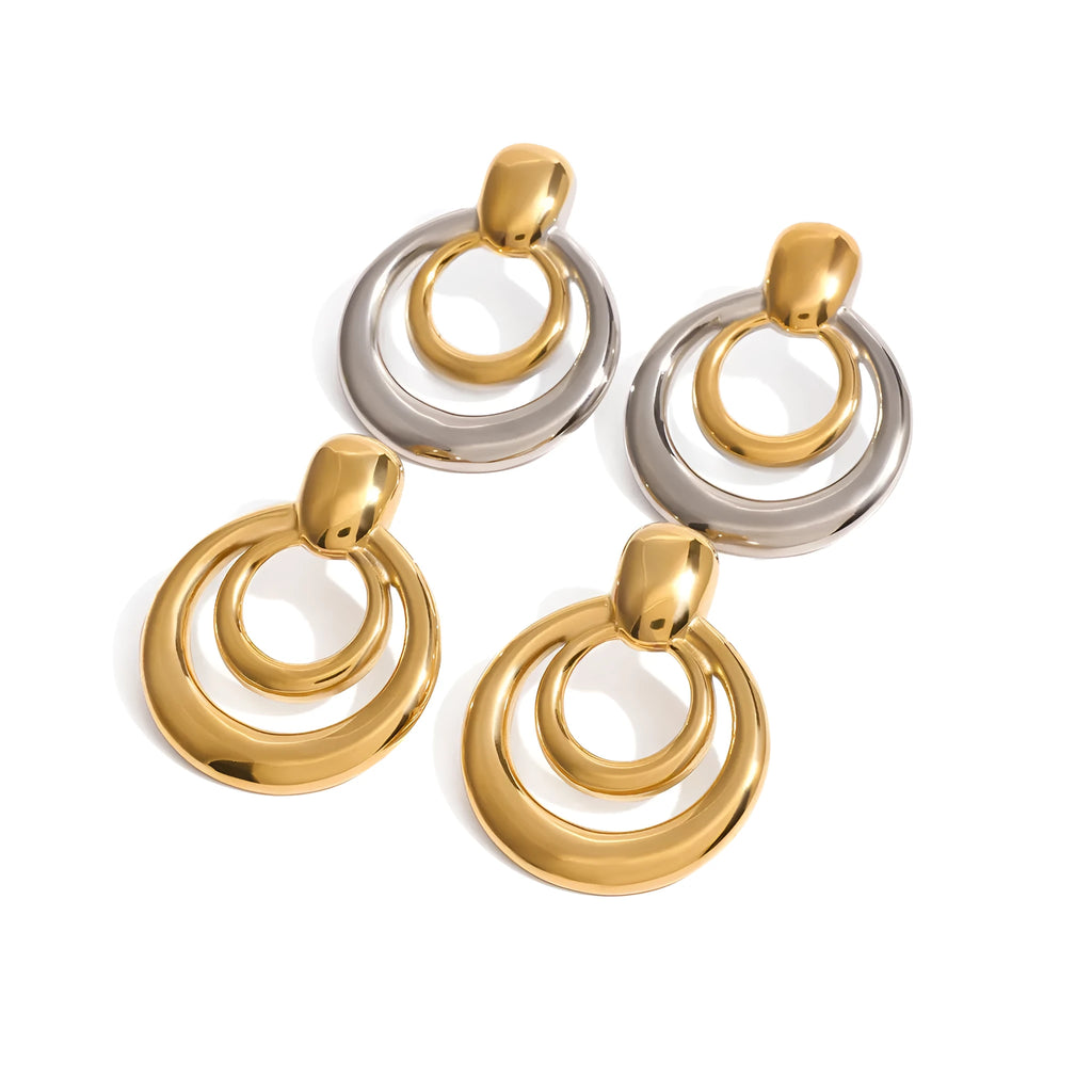 Gold-plated geometric stud earrings with hollow double-layer round design on titanium steel backing.