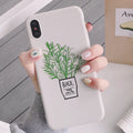 White silicone iPhone case with detailed green painted plant leaves design on the back.