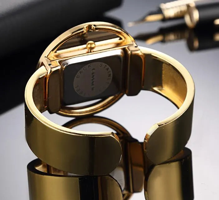 Women's adjustable cuff bracelet watch with 40mm dial, steel band, and choice of gold or silver finish