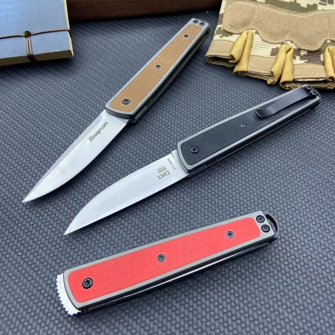 Closed and opened views of a black folding fruit knife showing the stainless steel blade and handle.