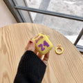 Silicone protective cover compatible with AirPods second generation in purple and yellow colour options