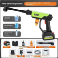 Green wireless high-pressure water gun with metal nozzle and multiple attachments on a table