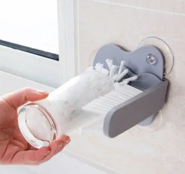 Grey rotating double-headed cup brush with suction cups for wall attachment