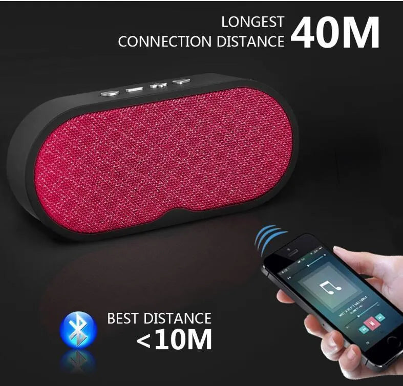 Portable grey Bluetooth speaker with HD microphone on a table