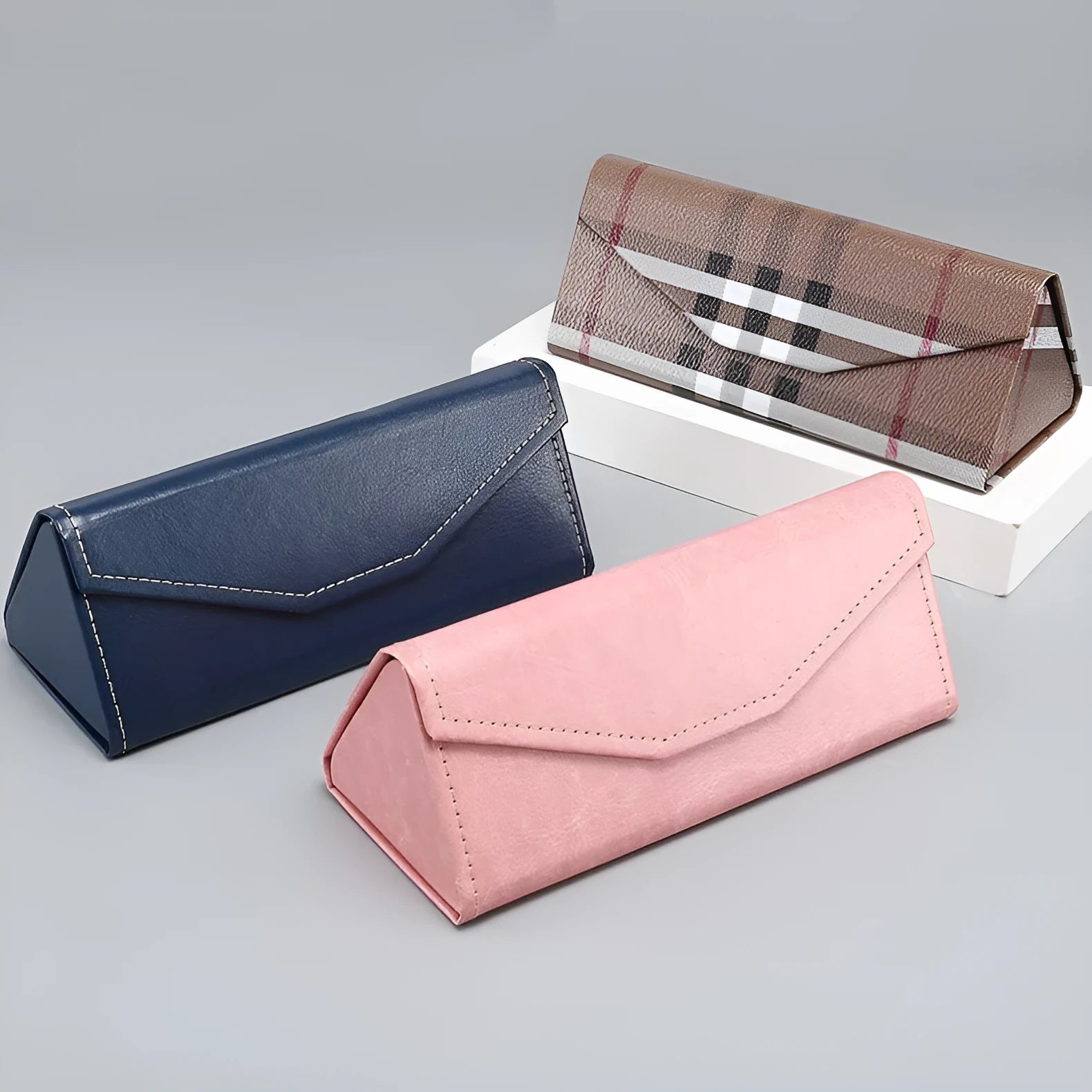 Handmade triangular folding glasses case in PU cowhide, shown in black colour, sized 160mm by 66mm.
