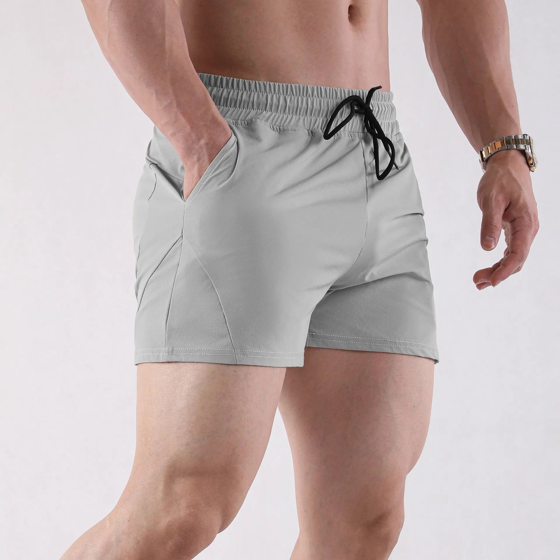 Men's thin grey polyester basketball shorts with elastic waistband, shown laid flat.