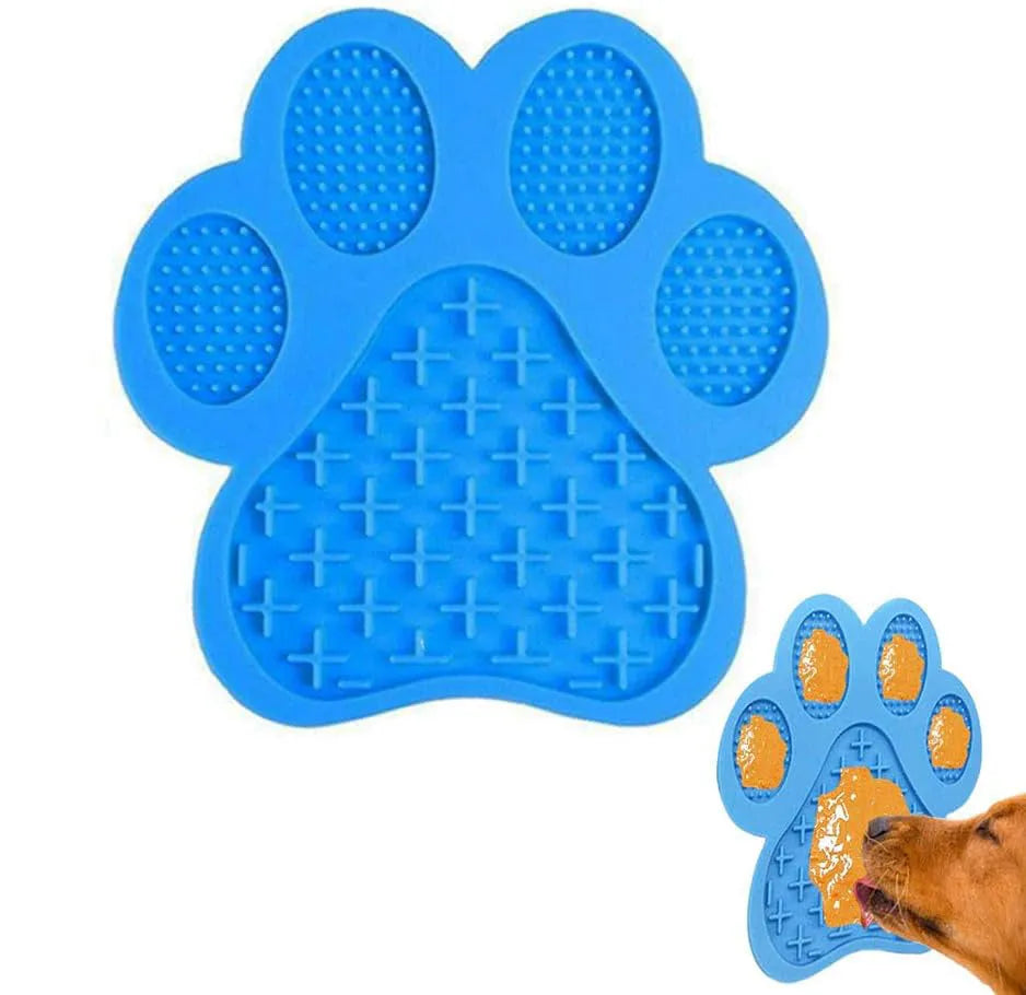 Blue bone-shaped silicone dog licking mat with suction cups on a white tile wall.